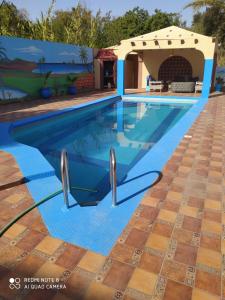 a swimming pool in a villa with a blue swimming pool at Riad ward in Agadir