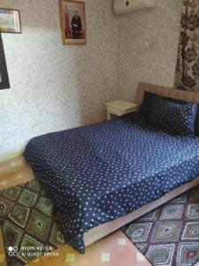 a bedroom with a bed with a blue comforter at Riad ward in Agadir