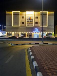 a building with a street in front of it at night at الساعه 60 الفندقيه in Dammam