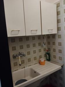 a kitchen sink with two white cabinets above it at MAISON SAN FRUTTUOSO in Genova