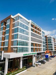 a large office building with a sign for a car dealership at Sabırlar City Suites Hotel in Trabzon