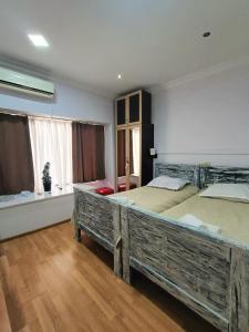 a large bedroom with two large beds in it at Guest House Lili in Batumi