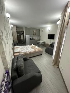 a living room with a bed and a couch at ORBI City studio 536 in Batumi