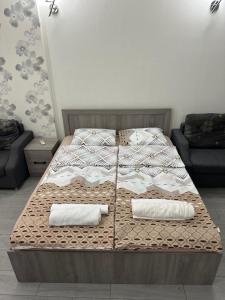 a bed with two pillows on it in a room at ORBI City studio 536 in Batumi