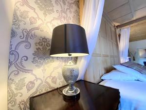 a lamp sitting on a table next to a bed at Lomond 6 with Private Hot Tub - Fife - Loch Leven - Lomond Hills in Kelty