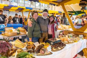 a man and woman standing in front of a table of food at Hotel Garni Bel-Ami in Galtür