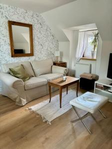 a living room with a couch and a table at Le cocon, T2, hypercentre in Cherbourg en Cotentin