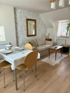 a living room with a table and a couch at Le cocon, T2, hypercentre in Cherbourg en Cotentin +11 photos