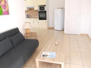 sala de estar con sofá y mesa en P2 4 prs, 200 m plage et cv en Le Grau-du-Roi