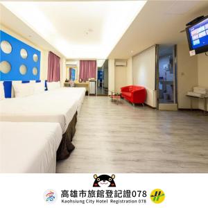 a hotel room with two beds and a television at Newrise Hotel in Kaohsiung