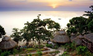 a group of huts with a view of the ocean at Koh Jum Resort in Ko Jum