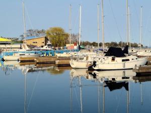 a group of boats docked in a marina at Elegant 4 BR 3.5 Bath Oasis: Mins frm Coburg Beach in Cobourg