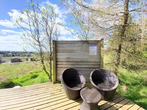 two baskets sitting on top of a wooden deck at Blair Tiny House with Private Hot Tub - Pet Friendly- Fife - Loch Leven - Lomond Hills in Dunfermline