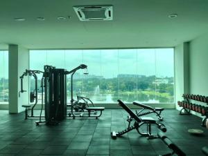 a gym with cardio equipment in front of a large window at Plaza @ Kelana Jaya 2 Bedroom House NEW 2024! in Petaling Jaya