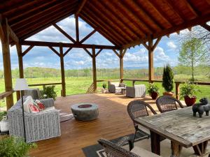 a wooden patio with a wooden table and chairs at The Dogwood Inn in Blue Ridge