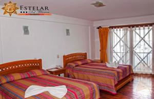 Кровать или кровати в номере HOTEL ESTELAR del TITICACA