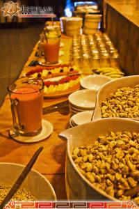 a long table with food and drinks and nuts at HOTEL ESTELAR del TITICACA in Copacabana