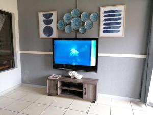 a living room with a flat screen tv on a wall at 78 Cabanas Del Mar in Kingsborough