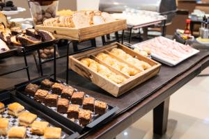 a buffet filled with different types of bread and pastries at Blank Hotel Recoleta in Buenos Aires