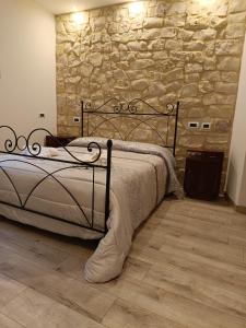 a bed in a room with a stone wall at Il Casale Di Ginetto in Cascia +84 photos