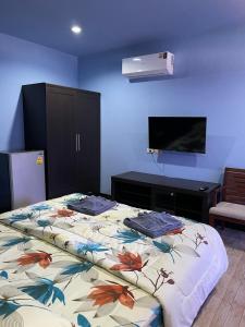 a bedroom with a bed with a flower patterned blanket at Mipiace in Kamala Beach