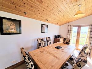 a dining room with a wooden table and chairs at Torridon 12 with Private Hot Tub - Fife - Loch Leven - Lomond Hills in Kelty