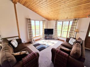 a living room with two couches and a tv at Torridon 12 with Private Hot Tub - Fife - Loch Leven - Lomond Hills in Kelty