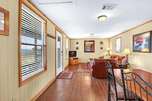 a living room with a couch and a table at Lighthouse Hill Ranch - Grey House in Johnson City