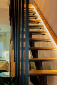a wooden staircase in a room with at Ethra Suite 1 in Volos +31 photos