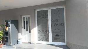a sliding glass door with a sign on it at Hotel Quo Vadis in Međugorje