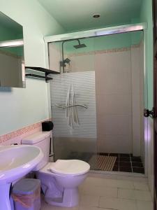 a bathroom with a toilet and a sink and a shower at Mipiace in Kamala Beach