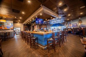 a restaurant with a bar with stools at Holiday Inn Brookfield - Milwaukee, an IHG Hotel in Brookfield