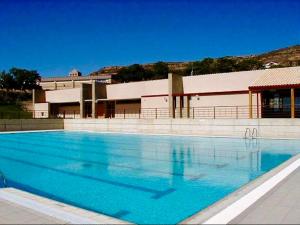 a large blue swimming pool in front of a building at Casa Julita Etxea in Morentin