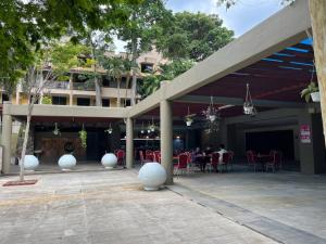 a restaurant with tables and chairs in a courtyard at Cozy 4BR 7Pax MMU Cyberjaya University Tamarind Square in Cyberjaya