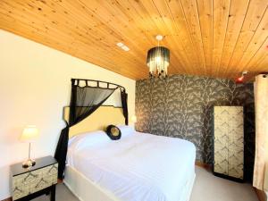 a bedroom with a bed and a wooden ceiling at Torridon 12 with Private Hot Tub - Fife - Loch Leven - Lomond Hills in Kelty +9 photos