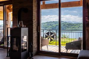 a room with a fireplace and a view of the mountains at Stylchyn Park-Apartament z Widokiem na Jezioro Czorsztyńskie - by Upstairs in Kluszkowce