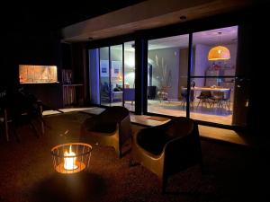 a living room with two chairs and a table and a lamp at LUNALBA in Potrero de Garay