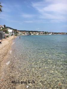 a beach with a rocky shore and the ocean at Hotel Barba in Urla