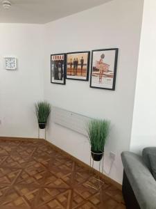a living room with three pictures on the wall at Luna Church Conversion 1 in Blackpool