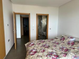 a bedroom with a large bed with flowers on it at Marchica nador in Nador