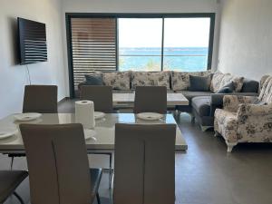 a living room with a couch and a table and chairs at Marchica nador in Nador