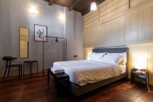a bedroom with a bed and a table and a stool at Aayu Stewart in George Town