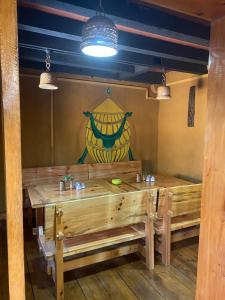 a dining room with a wooden table and a vase at Amas Village Lodge in Paro