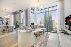 a living room with a couch and a large window at Burj Khalifa & Fountain Views, Exclusive Apartment in Burj Vista Building in Dubai