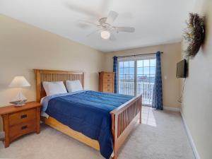 a bedroom with a bed and a ceiling fan at Summers at Sumner in Seaside Heights