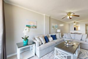 a living room with a couch and a table at Emerald Surf 102 in Navarre