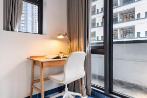 a desk with a chair next to a window at Habyt Bridges - 66 Staunton Street in Hong Kong