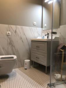 a bathroom with a sink and a toilet at Quebra Costas House in Coimbra