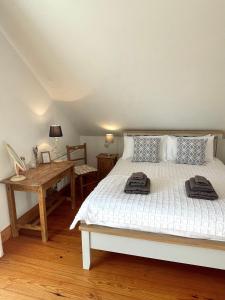 a bedroom with a bed and a wooden table at Bed & Breakfast - Shanakeever Farm in Clifden