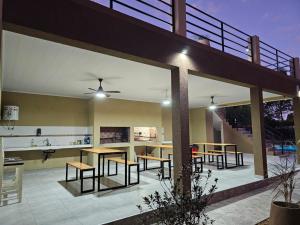 a patio with wooden tables and chairs in a house at Villa Termal Norte in Federación